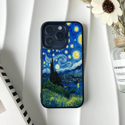 Phone case featuring a lush green hillside with yellow wildflowers leading down to a village under a blue starry sky.
